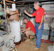 G. Neil Scott and part of the team inspect the water heater at a home in Stamford CT in 2013. Scott is the owner of Scott and Scott, Inc. Home Inspection Services of Stamford. Photo: Bob Luckey / Stamford Advocate and Greenwich Times